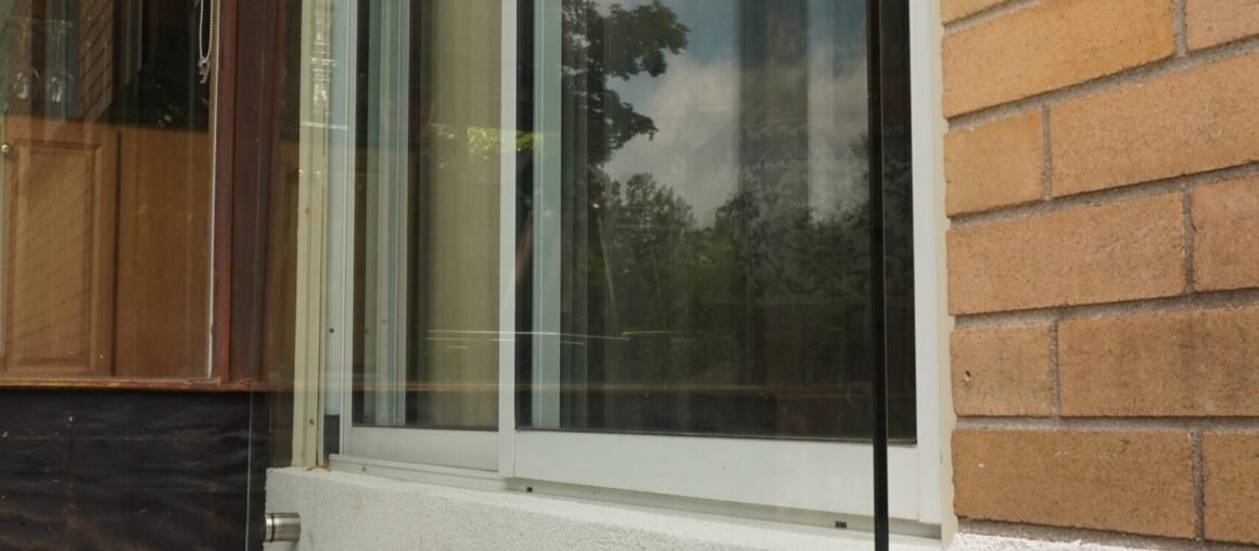 Glass balcony railing detail at a residential entrance